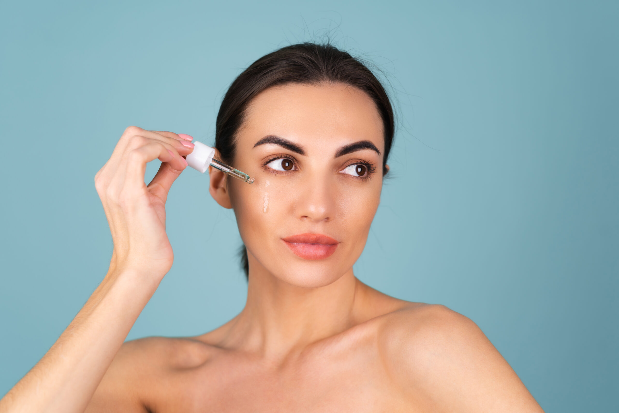 Woman applying serums